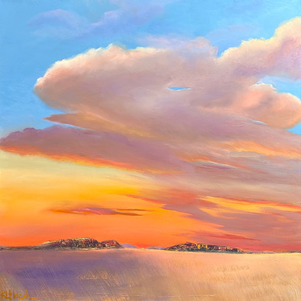 This artwork beautifully captures a serene desertscape during a sunset. The sky dominates the composition with a vast expanse of soft, billowing clouds
rendered in warm tones of pink, orange, and lavender, blending seamlessly into a cool blue
at the top. The horizon is low, with two dark, rocky landforms breaking the expanse between
the sky and the vast desert below. 